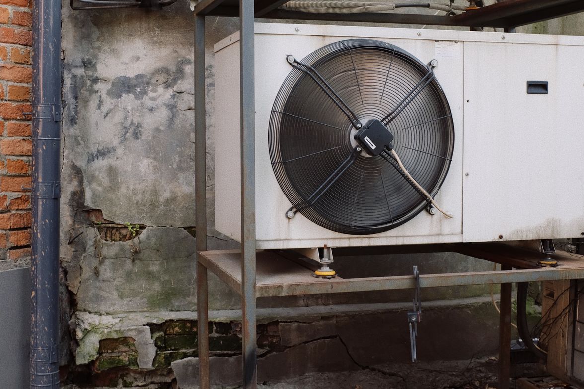 Bank of commercial air conditioning condenser units mounted on an exterior equipment rack.
